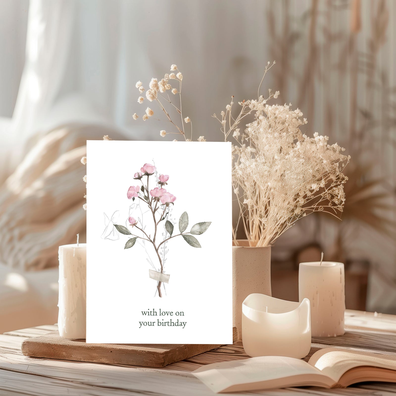 Greeting card with floral design and candles on a wooden surface
